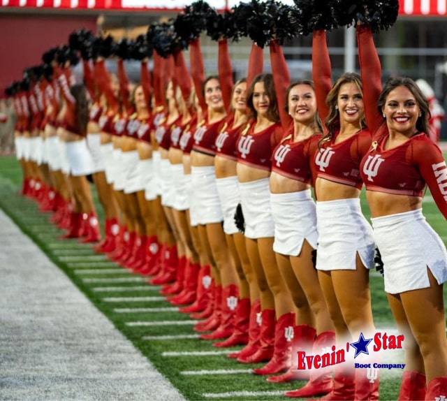Energetic cheerleader team lined up in uniform with vibrant cheer boots